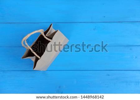 paper bag design on blue wooden background