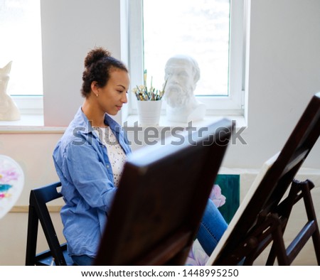 African american student working in a painting studio