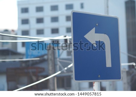 Left Turn Sign and electric pole in the City 