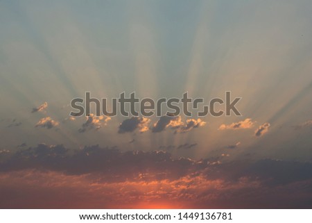 Morning sunrise light rays with dramatic clouds at sky
