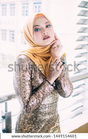 Islamic beautiful woman in a Muslim dress standing