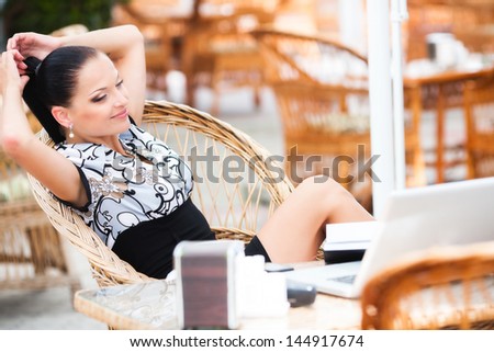 Young beautiful business woman in cafe