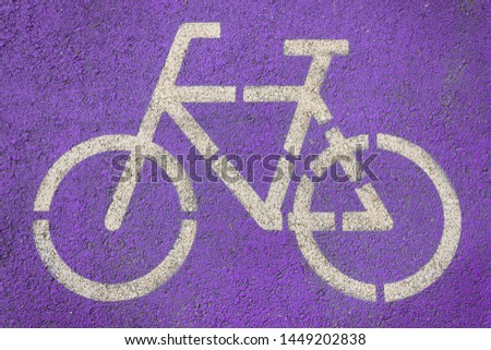 White bicycle symbol on the purple road in the bicycle path