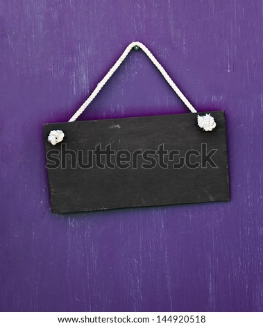 blackboard hanging on the purple door