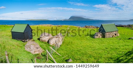 Panoramic view of Faroe islands seashore with traditional farm houses, summer time