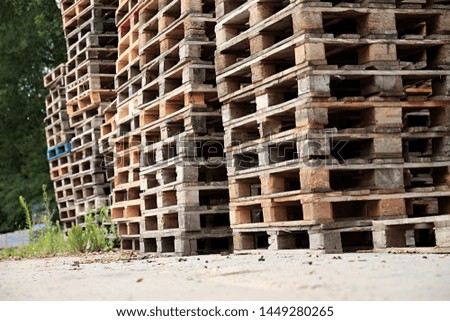 wooden pallets stacked high on top of each other in a companys factory yard in london no people stock image and stock photo