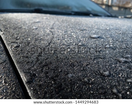 White frost on the car body. Small layer of snow. Russia