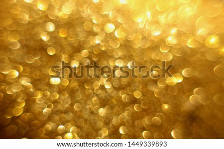 Golden glitter christmas abstract bokeh background. Blurred sparkles festive backdrop