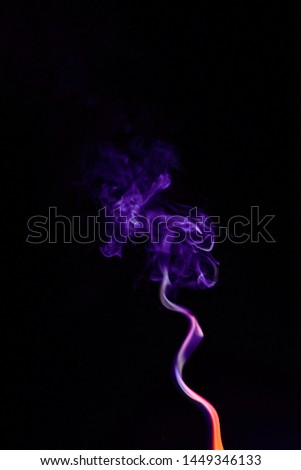 Close up movement of colorful smoke isolated on black background.Abstract background smoke curves and wave on black background.