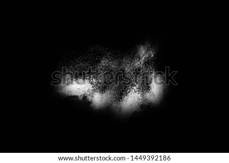 White powder explosion on black background. Colored cloud. Colorful dust explode. Paint Holi. 