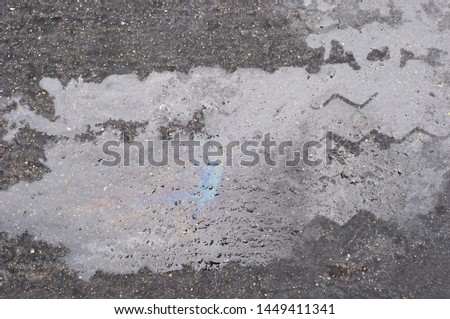 Oil stains reflect on the road.
