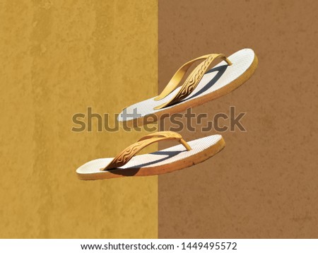 footwear sandals (sandal jepit) with yellow and brown background. Royalty-Free Stock Photo #1449495572