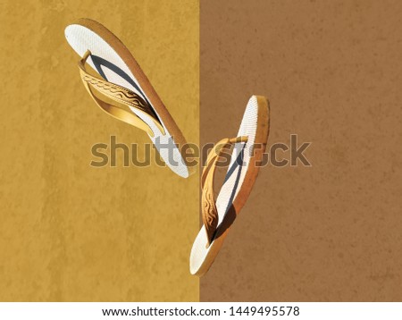 footwear sandals (sandal jepit) with yellow and brown background. Royalty-Free Stock Photo #1449495578