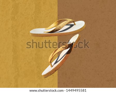 footwear sandals (sandal jepit) with yellow and brown background. Royalty-Free Stock Photo #1449495581