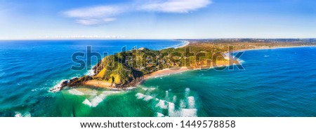 Byron bay and famous lighthouse on the top of headland facing Pacific ocean - the most eastern part of Australian continent. Royalty-Free Stock Photo #1449578858