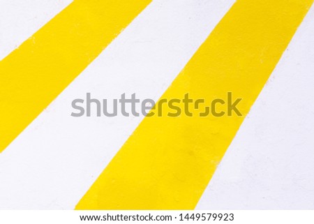 Wall painted in white and yellow as background and texture for design. Abstract wall in yellow and white lines.  