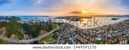 Panorama of Ha Long City, Vietnam, with Bai Chay bridge. Near Halong Bay, UNESCO World Heritage Site. Popular landmark, famous destination of Vietnam. View from center city to Ha Long bay.