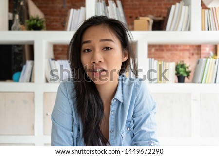 Head shot portrait Asian online teacher woman speaking by webcam, distant learning language, looking at camera, job interview, teenage girl making video call, female vlogger recording vlog Royalty-Free Stock Photo #1449672290