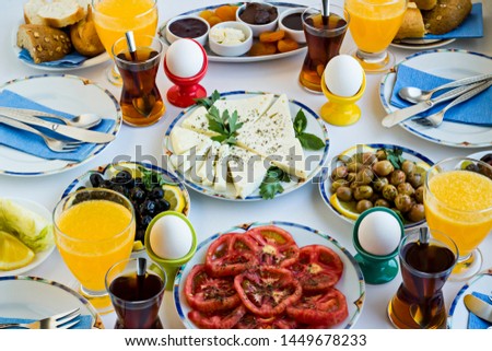 Elegant breakfast table with boiled eggs,tea and fresh orange juice