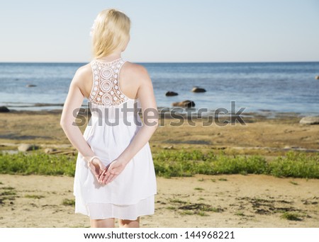 Young woman hold hands behind while enjoy weather