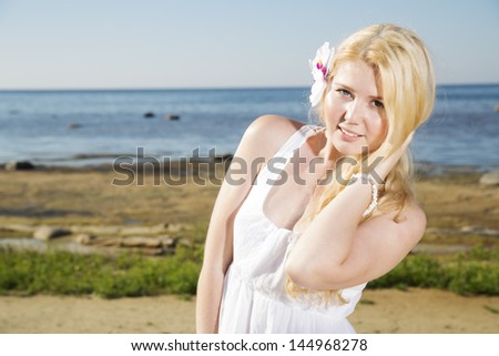 Zoomed woman with white flower in gold hairs