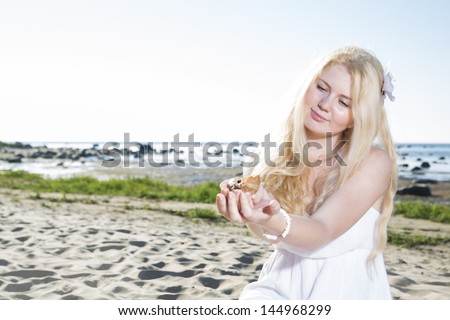 Young woman hold clam at her soft hands