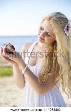 Woman in white dress marvel clam at hands