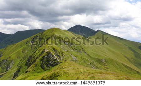 Romania, Rodnei Mountains, the eastern ridge of the massif, viewpoint from Omu Peak. Behind Ineu Peak, the second peak in the Rodna Mountains Royalty-Free Stock Photo #1449691379