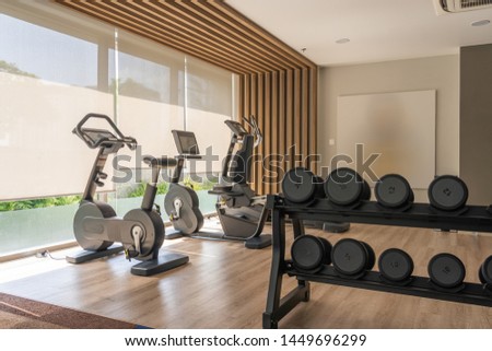 Luxury interior fitness machine and dumbbells in gym club