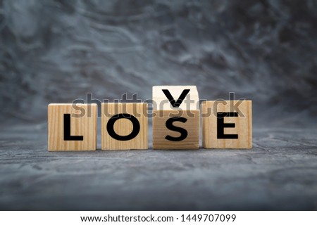 Wooden cube block with word LOVE change to LOSE. Concept of losing love and story love Royalty-Free Stock Photo #1449707099