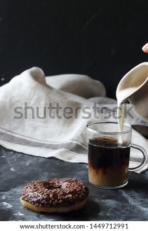 Chocolate donut and coffee on a black background