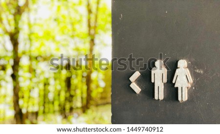 the male and female restroom signage which located next to the park