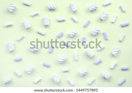 Colorful marshmallow laid out on lime paper background. pastel creative texture