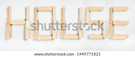 the word «house» written in letters of wooden bars