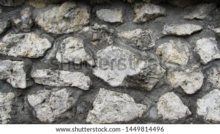 background of gray stone. the wall of a large gray stone. stone wall texture