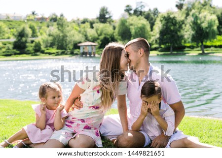 Young and happy family having a good time at the park.