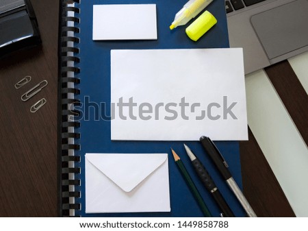 desk with orderly office work material and blank envelopes and cards for text design