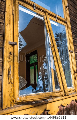 Abandoned wooden building with a broken window