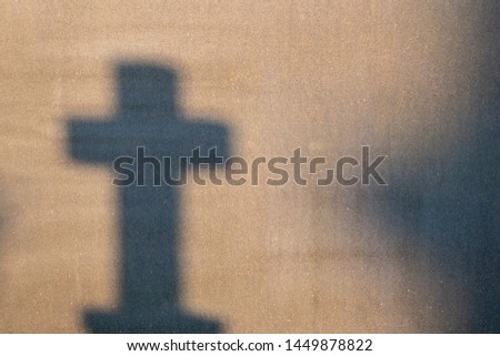 Cemetery reflection on a granite tombstone. The shadow of the crosses and tombstones.