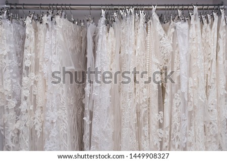 Ladies chiffon blouses on wooden hangers. White and black lace blouses. Fashion Banner background.