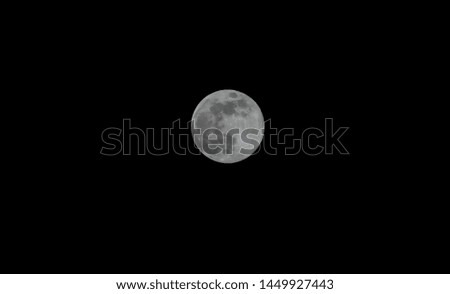 Full moon in the dark night sky