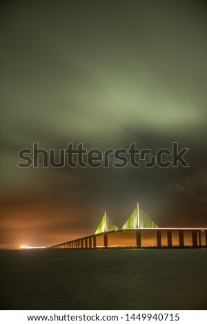 Sunshine Skyway Bridge in Tampa Bay Saint Petersburg Florida at night in a stormy sky