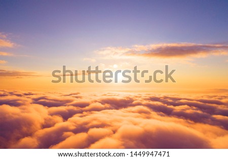 Aerial view White clouds in blue sky. Top view. View from drone. Aerial bird's eye clouds. Aerial top cloudscape. Texture of clouds. View from above. Sunrise or sunset over clouds Royalty-Free Stock Photo #1449947471