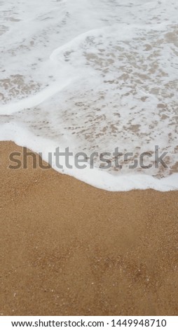 Sea Waves meet Sand Coastline