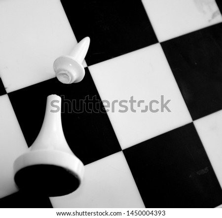 black and white chess lying on the board