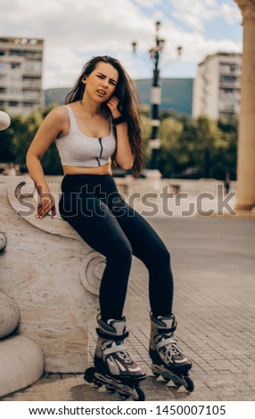 Time to rest. Attractive young woman in rollers relaxing while sitting outdoors