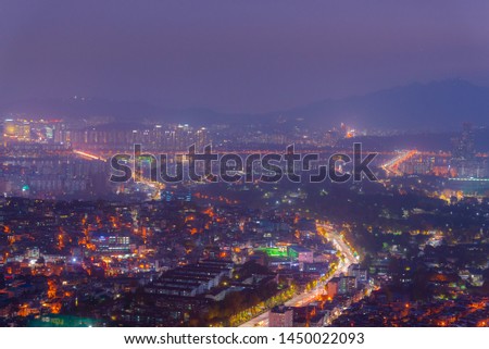 The light of city in the mist of night time. Picture with grain and color from film simulation filter. Seoul, South Korea