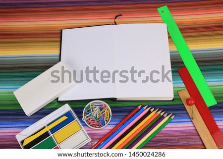 Back to school, Assortment of colored pencils, pens and rulers, on a very bright rainbow abstract background, top view. Bright background and colors form extraordinary thinking 