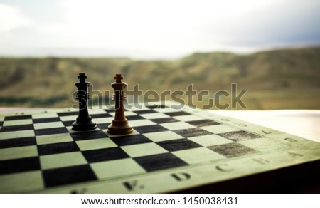 Chess board game concept of business ideas and competition. Chess figures on a chessboard. Outdoor sunset background. Selective focus
