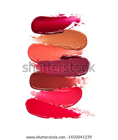 Multi colored lipstick swathes background isolated on white
